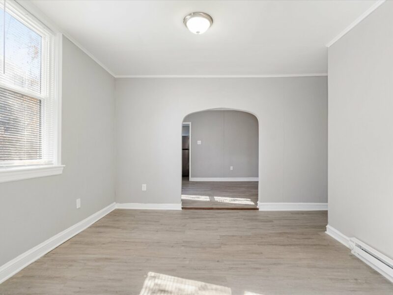 Family room at 5248 Cordelia Avenue with luxury vinyl plank flooring and arched doorway to adjacent space.