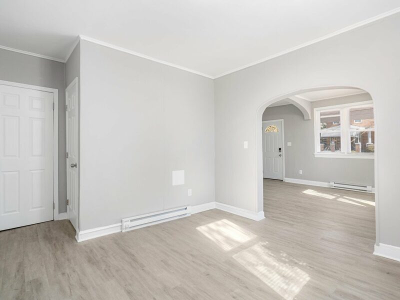 Family room at 5248 Cordelia Avenue with vinyl plank flooring, arched doorway, and view into the kitchen.