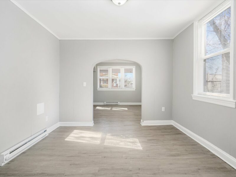 Family room at 5248 Cordelia Avenue with vinyl plank flooring, natural light, and view into the living room.