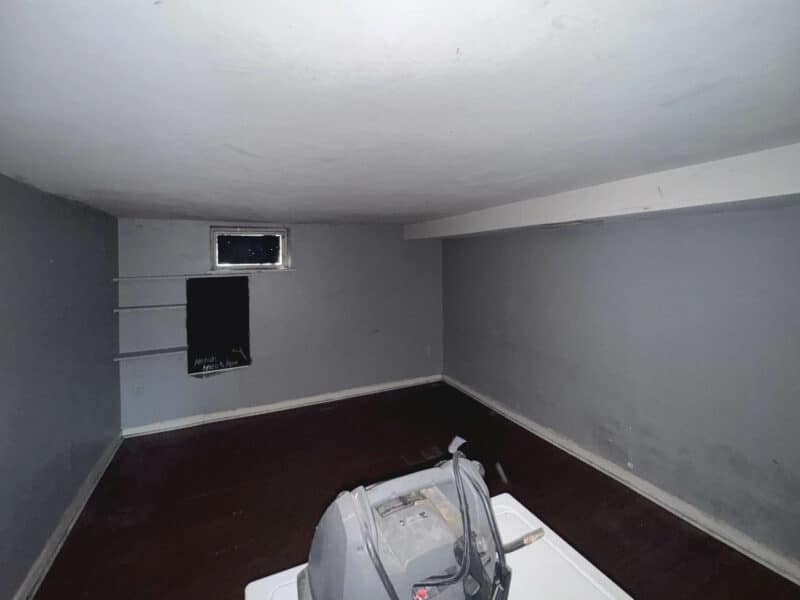 Partially finished basement at 1346 Carroll Street with painted walls and carpet flooring.