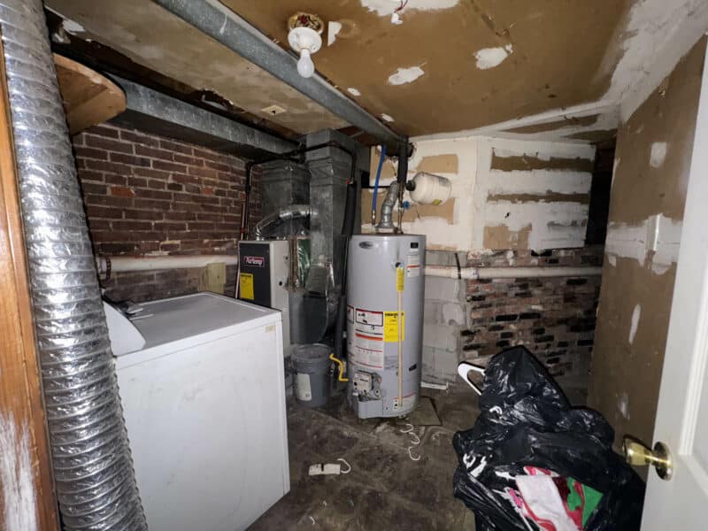 Basement utility area at 1346 Carroll Street with washer, water heater, and HVAC system.