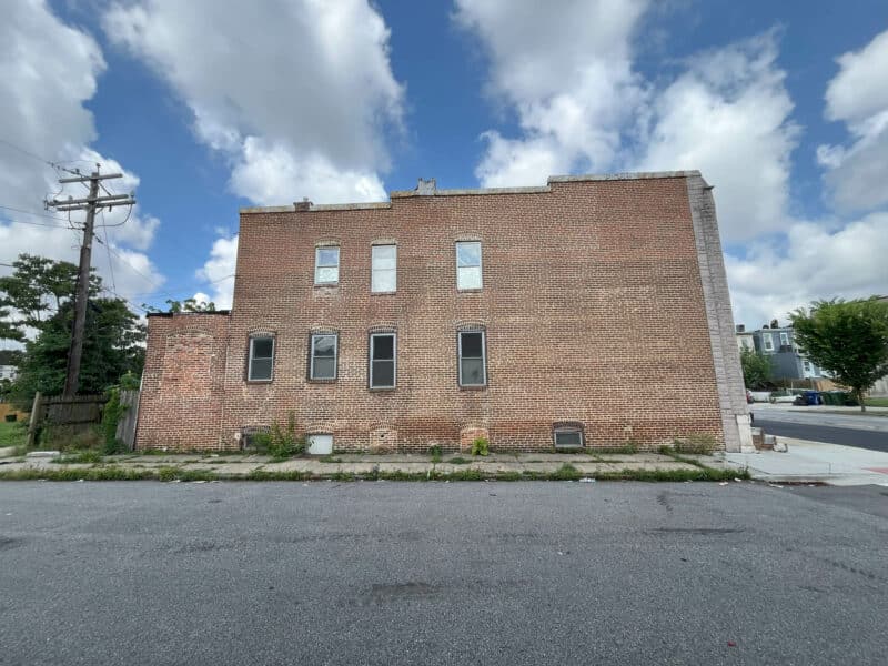 Side view of 2307 E. Preston Street showing brick façade, rear access, and multiple windows.
