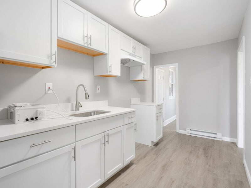 Kitchen at 5248 Cordelia Avenue with white cabinetry, stainless steel appliances, and updated lighting.
