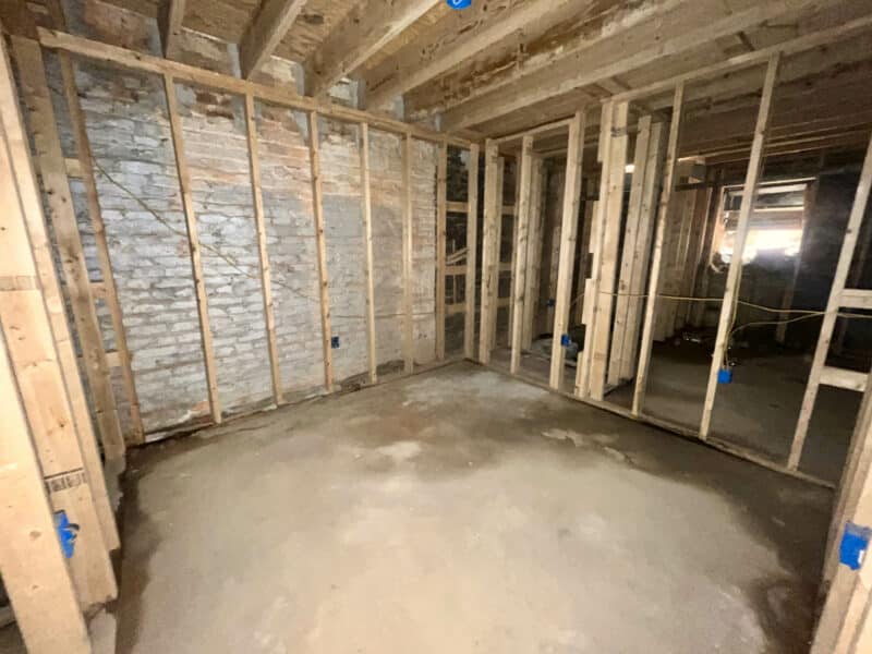 Framed interior room with concrete flooring and exposed masonry at 539-549 45th Street