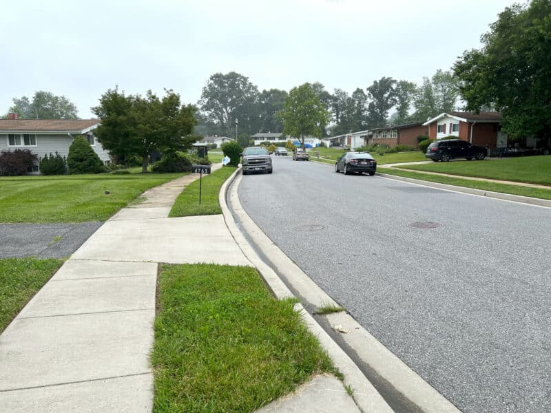 Residential street view of Bonnie Brae Road in Baltimore County, featuring sidewalks, manicured lawns, and single-family homes.