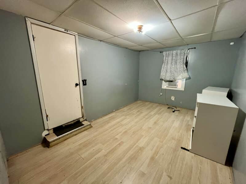 Unfurnished room in Apartment 3 at 4831 Belair Road with vinyl flooring and small window.