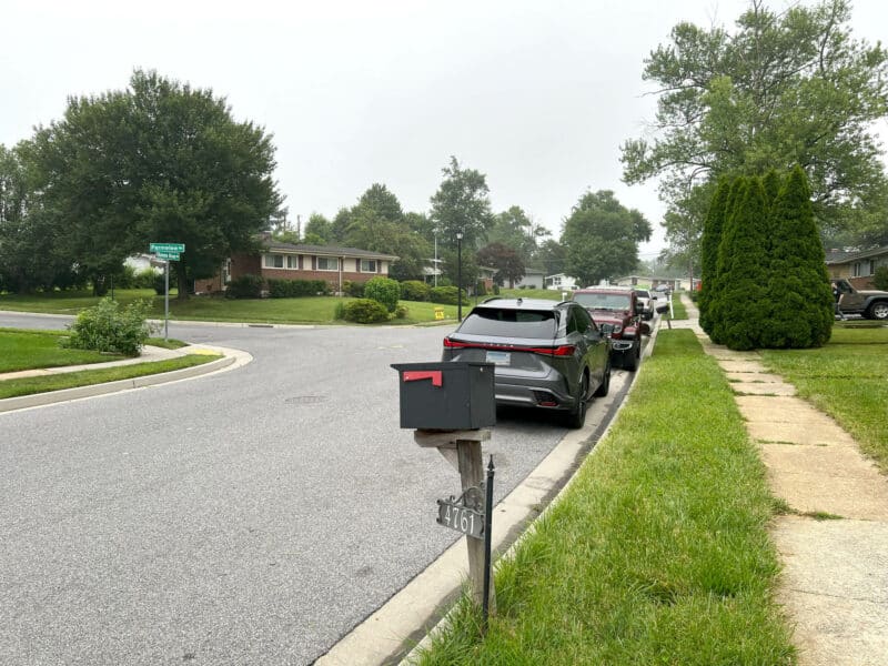 Mailbox and street view outside 4761 Bonnie Brae Road in Baltimore County, with parked cars and surrounding suburban homes.