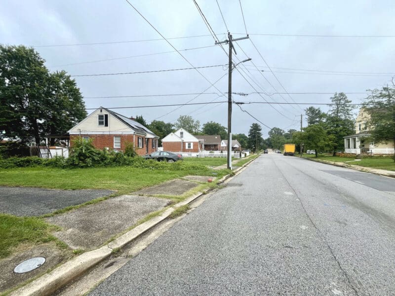 Street view of Winthrope Avenue in Baltimore’s Hamilton neighborhood, showing single-family homes, parked cars, and overhead utility lines.