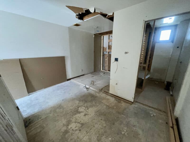 Interior room showing exposed subflooring and partial drywall installation