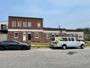 Front view of 539-549 45th Street in the Harbor View neighborhood of Dundalk, Baltimore County – brick corner apartment building arranged for 8 units, zoned RO.