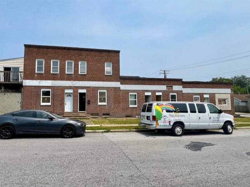 Front view of 539-549 45th Street in the Harbor View neighborhood of Dundalk, Baltimore County – brick corner apartment building arranged for 8 units, zoned RO.