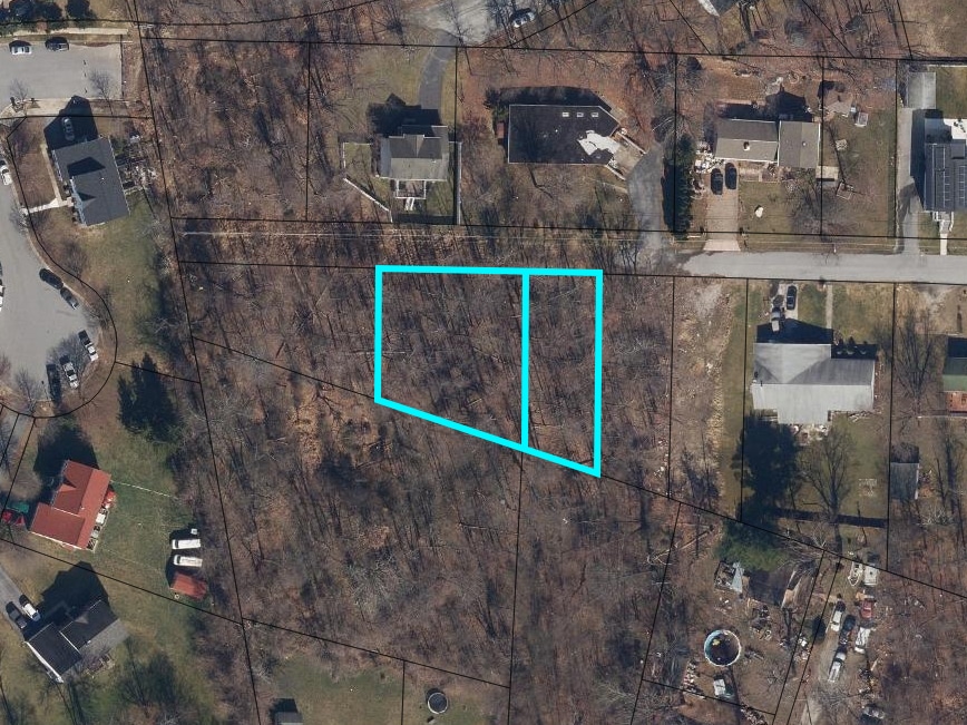 Aerial view of two adjacent unimproved residential lots outlined in blue on Valley Forge Road in Randallstown, Maryland.