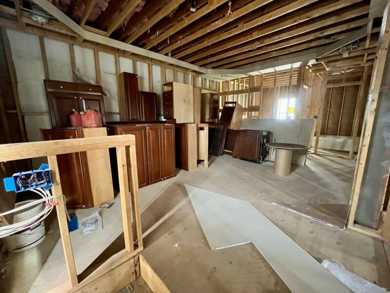 Interior space with exposed ceiling joists and stacked cabinetry