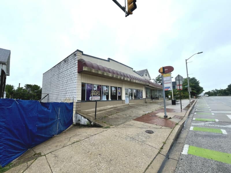 Street view of a commercial building on Harford Road with a corner storefront and ramp entry.