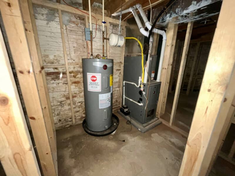 Water heater and forced air furnace installed in framed utility room