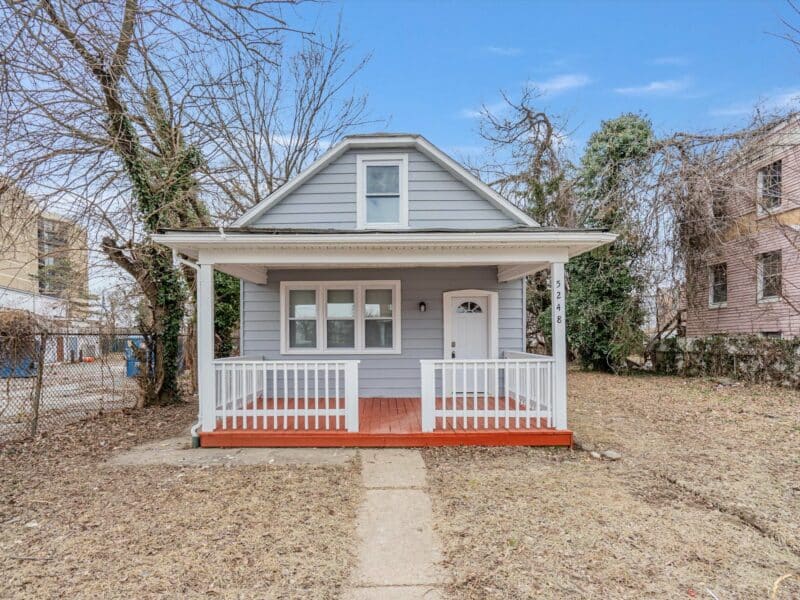 Front view of 5248 Cordelia Avenue, a renovated gray bungalow with white trim and a covered front porch in Baltimore’s Arlington neighborhood.