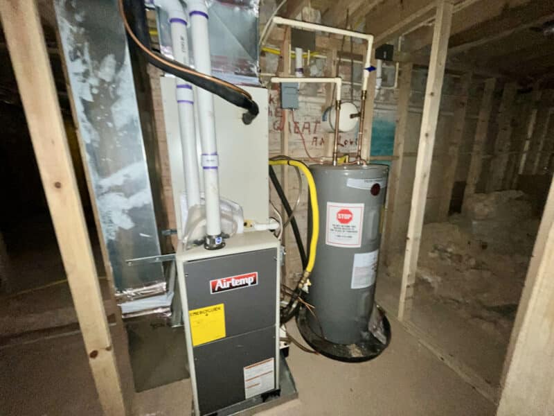 Forced air furnace and water heater setup in framed utility area