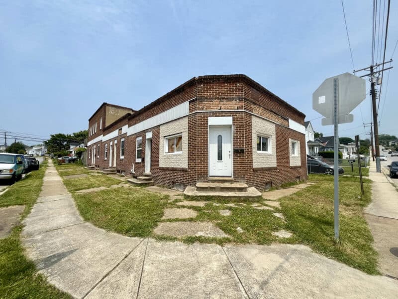 Corner view of 539-549 45th Street at Fait Avenue in Dundalk’s Harbor View neighborhood – brick mixed-use building framed for 8 units on 0.14± acre lot.