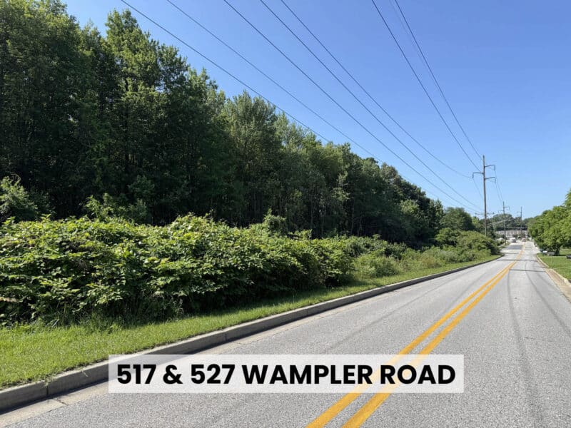 Street view along Wampler Road adjacent to wooded development site in Middle River, MD.