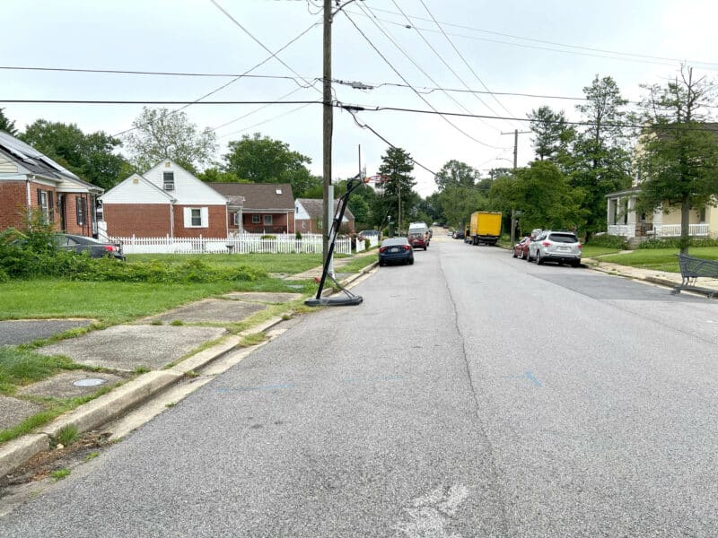 Street view of Winthrope Avenue in Baltimore’s Hamilton neighborhood, showing single-family homes, parked cars, and overhead utility lines.