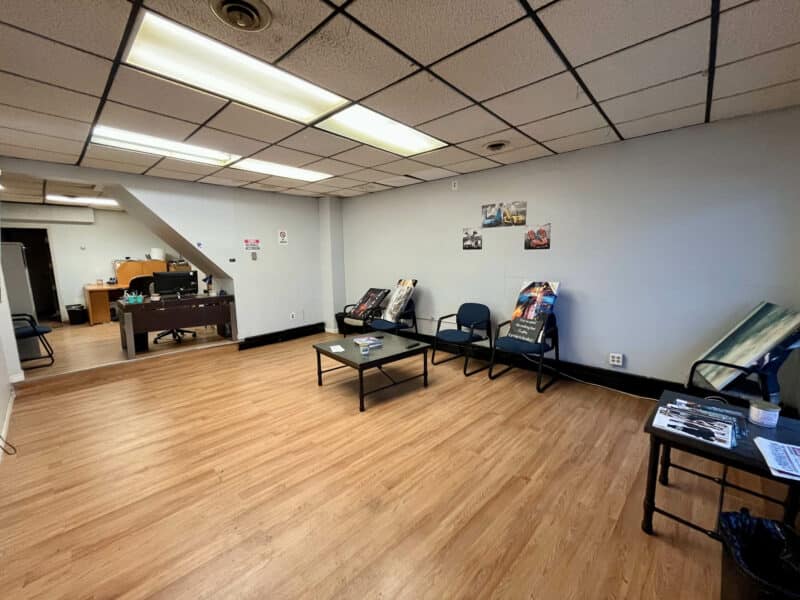 Interior of Tag & Title office at 4831 Belair Road showing reception area with seating and front desk.