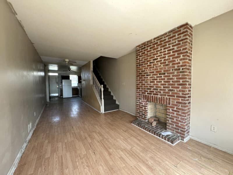 Living room of 1346 Carroll Street townhome featuring vinyl plank flooring, neutral color walls and natural light.