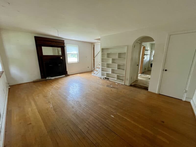 Living room with hardwood flooring, decorative fireplace, and built-in shelving at 5501 W. Forest Park Avenue.