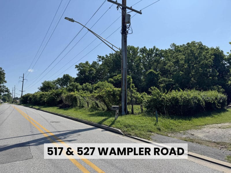 View of Wampler Road frontage with utility access and driveway cut near development parcel in Middle River, MD.