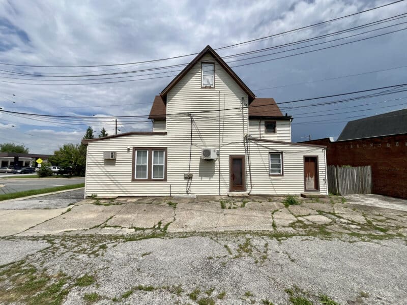 Rear view of two-story office building with large paved lot at 5706 Bellona Avenue