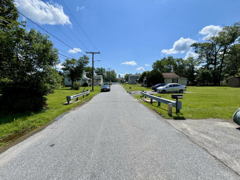 View of Valley Forge Road in Randallstown, MD, near 4812 Valley Forge Road with clear skies and residential homes.