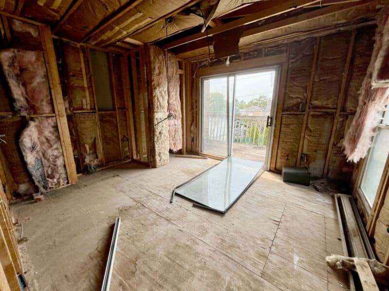 Framed rear apartment interior with insulation and large sliding glass doors to upper-level deck at 539-549 45th Street, Baltimore County.