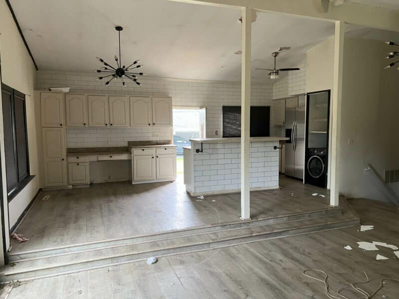 Kitchen and dining area at 4761 Bonnie Brae Road with white cabinetry, modern lighting, and open floor plan.