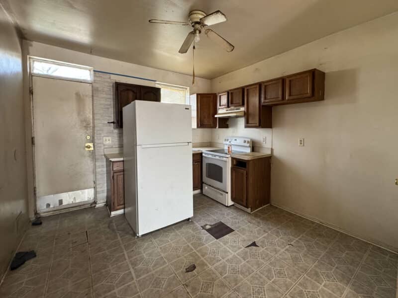 Kitchen at 1346 Carroll Street featuring laminate flooring, ample cabinetry, and access to the rear yard.