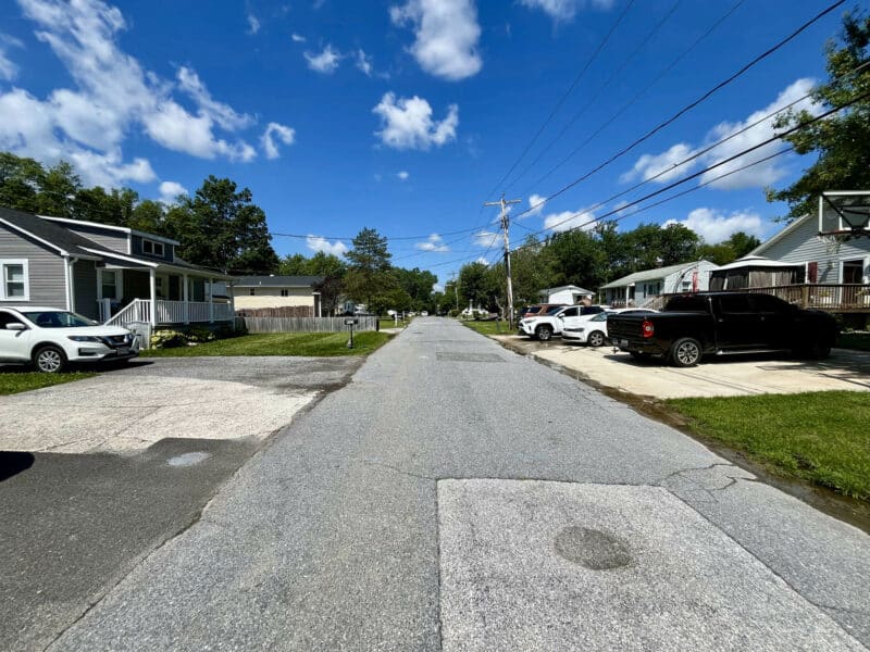 View of Valley Forge Road in Randallstown, MD, near 4812 Valley Forge Road with clear skies and residential homes.