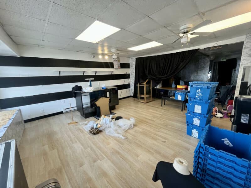 Interior of second commercial space at 4831 Belair Road with striped accent wall, open floor plan, and ceiling fans.