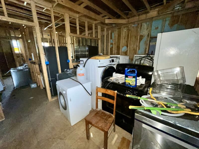 Apartment unit with exposed framing and scattered appliances at 539-549 45th Street in Dundalk