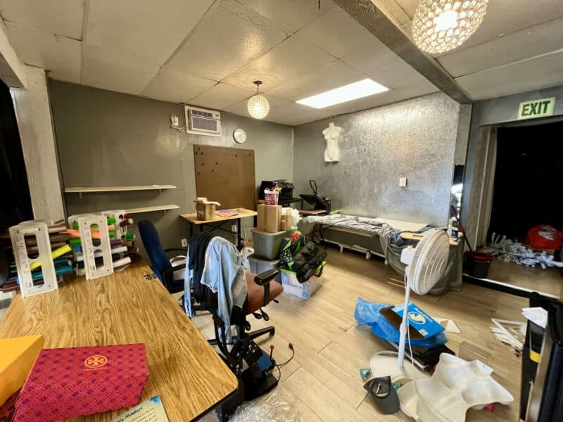 Interior workspace of second commercial unit at 4831 Belair Road with tables, supplies, and natural light.
