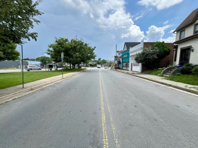 View looking down Bellona Avenue in Homeland with adjacent storefronts and clear skies