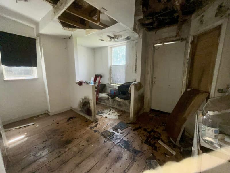 Bathroom area at 2307 E. Preston Street with exposed flooring and ceiling damage.
