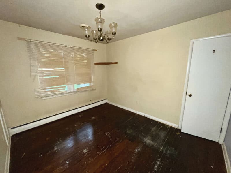 Third bedroom at 5900 Winthrope Avenue with hardwood floors, chandelier lighting, and neutral walls.