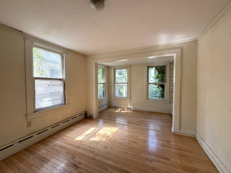 Large bedroom with bay window and built-in shelving.