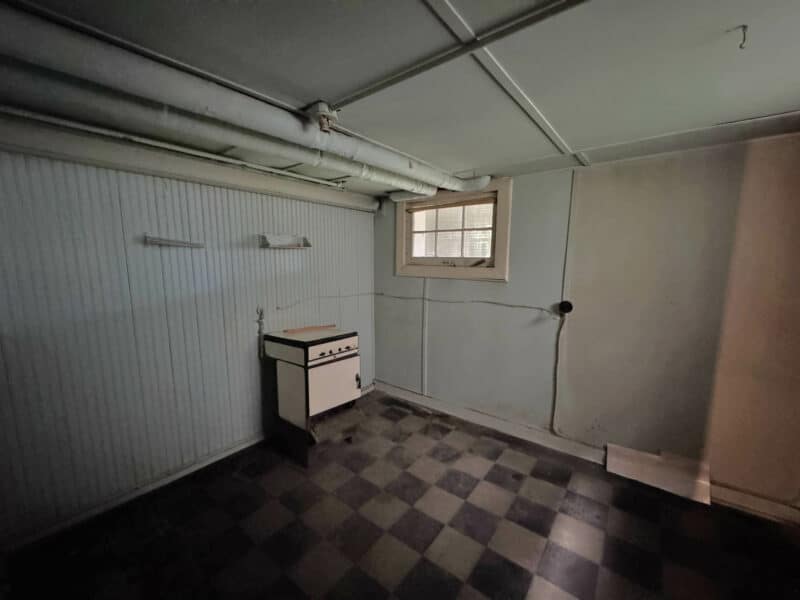 Basement club room with checkerboard vinyl flooring at 909 Jackson Street NE.