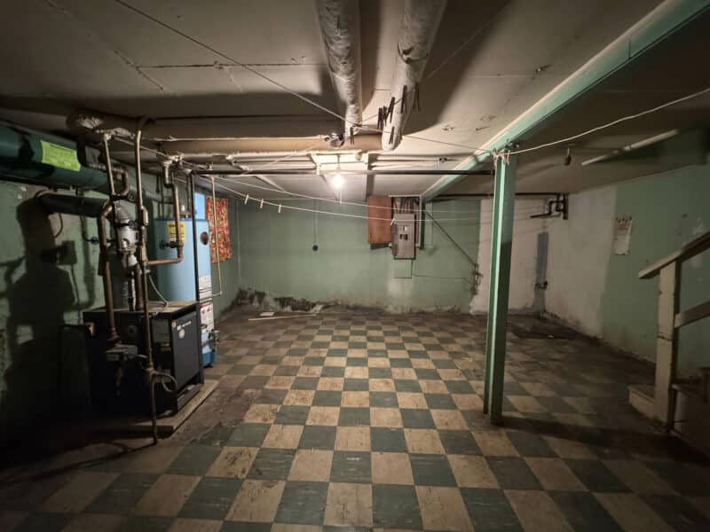 Basement mechanical room with boiler, water heater, and checkered tile flooring at 909 Jackson Street NE.