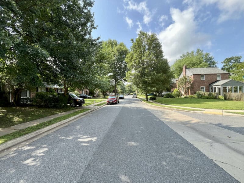 Residential street view of Dunmore Road with mature trees and well-kept single-family homes.