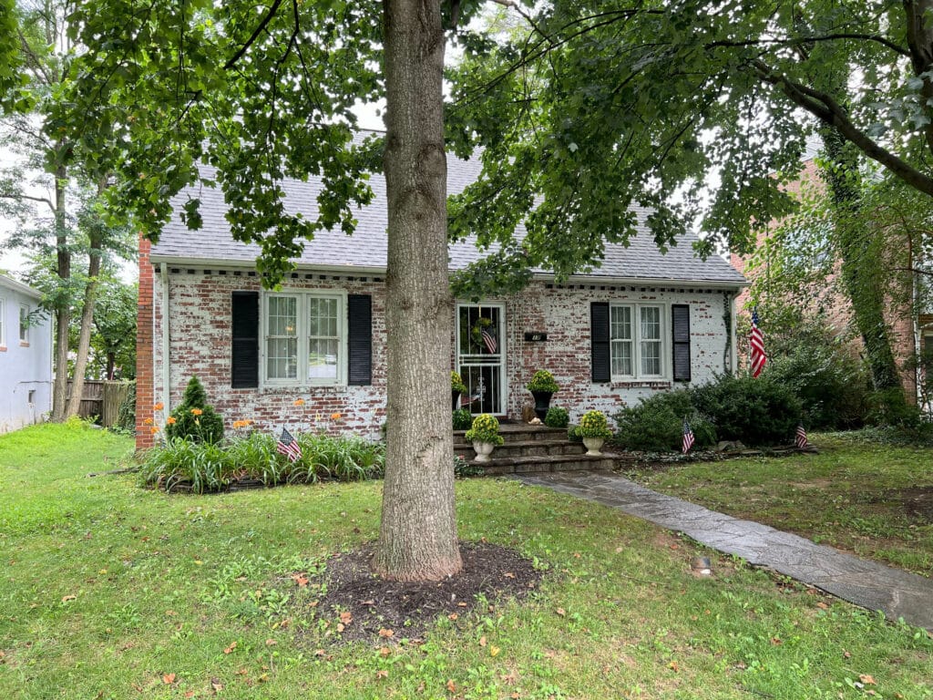 Front exterior view of brick and siding bungalow at 19 Dunmore Road with landscaped yard and flagstone walkway.