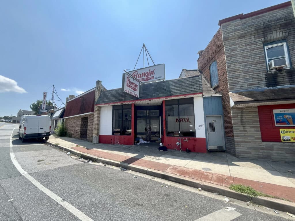 Street view of commercial building at 6705 Holabird Avenue with red and white storefront