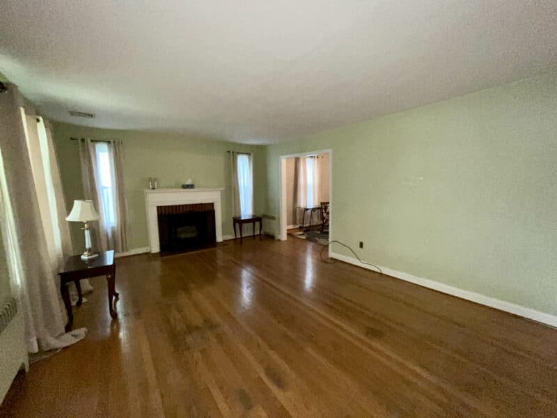 Spacious living room at 19 Dunmore Road with hardwood flooring, fireplace, and natural light from multiple windows.