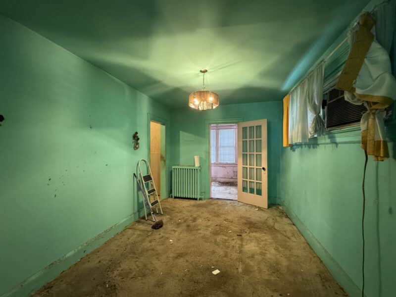 Dining room with chandelier, rear window, and carpeted flooring at 909 Jackson Street NE in Brookland, Washington DC.
