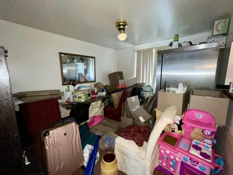 Cluttered dining room with ceiling fan, dining table, and assorted belongings at 12366 Bonfire Drive in Reisterstown.