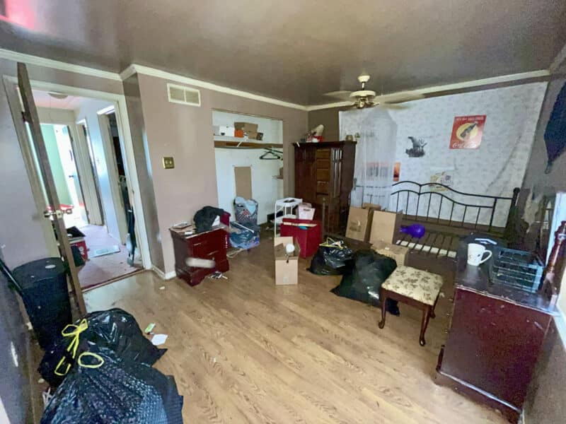 Primary bedroom with laminate flooring, ceiling fan, and miscellaneous storage items at 12366 Bonfire Drive in Reisterstown.